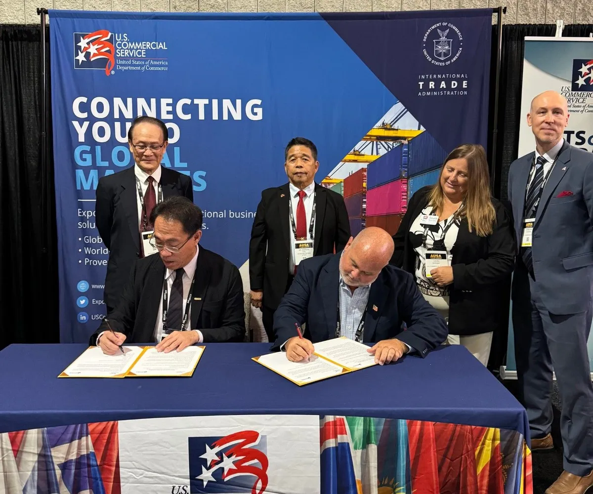 Representatives of Century Minsheng and SafeSky Systems USA seated at a table signing the MOU documents while colleagues stand behind them at AUSA 2026
